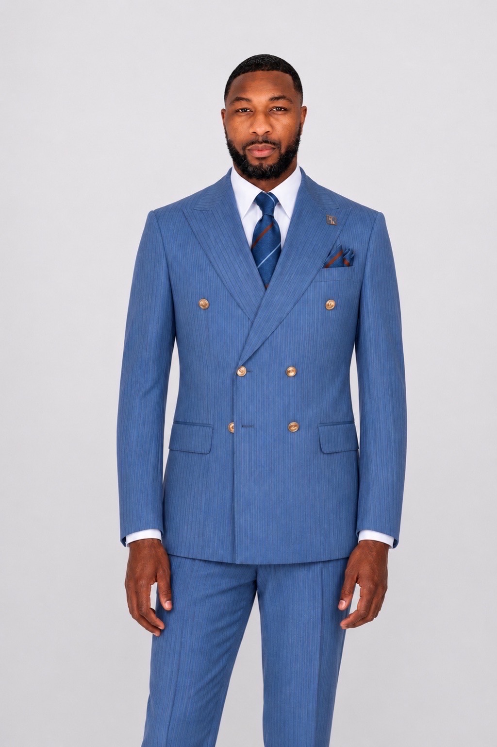 Model wearing blue pinstripe double-breasted suit with gold buttons by Harrison E Milano Berlin